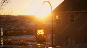 The golden glow of the setting sun with a vintage lantern lighting the foreground - parallax sliding motion Stock Video