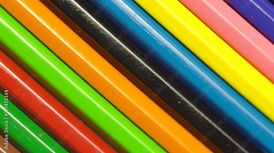 The ground pencils against a dark background. Top of color pencils. Color pencils turning on a black background. Close up. 4K footage. Macro. Macro shooting