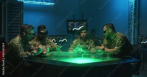 Soldiers remote controlling unmanned ground vehicle