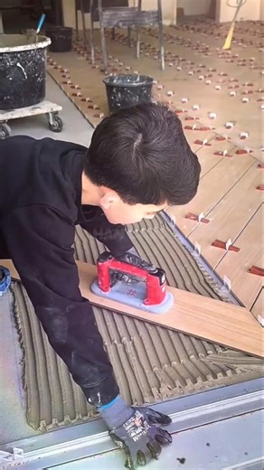 the process of installing wood-patterned floors carefully #shorts #construction #fyp #satisfying