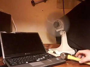 Angry office worker destroys laptop and COOL BREEZE fan
