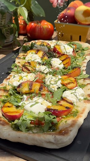 Lexi Harrison & Beth Sinclair on Instagram: "Grilled Peach & Burrata Flatbread with pesto, arugula and tomatoes 😍🍑🍕 Recipe below 👇 Grilling pizza dough is surprisingly easy and a delicious way to make pizzas and flatbreads at home! We topped this one with pesto, thinly sliced heirloom tomatoes, grilled peaches, burrata, arugula, basil, olive oil, hot honey, flaky salt and black pepper. It was SO good and a must try summer recipe! It only took us 20 mins from start to finish, so it’s perfect 