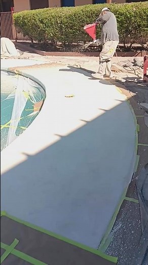 Applying texture to a concrete pool deck.