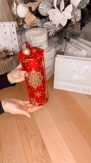 Muna Nijmeh on Instagram: "How To Wrap A Cylinder Gift 🎁 Here’s the easiest way to wrap a cylinder gift. 1. Measure & cut the paper 2. Wrap the paper around and tape 3. Cut around the sides to make flaps 4. Pull each one down and secure with tape 5. Finish with ribbon SAVE THIS POST! #giftwrapping #holidayseason #christmasdecor #holidaymood #christmascheer"