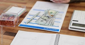 Insurance claim form in dollars and insurance agent concept