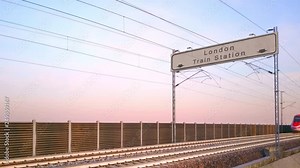 london train station signboard,train travels under railway billboard