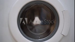 Washing machine washing clothes. Washing clothes with laundry detergent. Washing machine in the process of working Stock Video