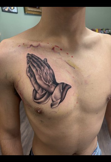 Inspiring Chest Piece Tattoo Featuring Praying Hands