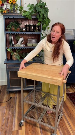 Origami Foldable Kitchen Cart is a rolling kitchen cart with a solid wood top designed for small