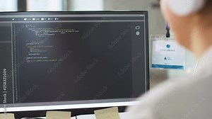 programming and technology concept - female programmer with script on computer screen working at office