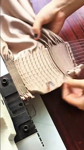 Creating decorative pleats on fabric using a specialized smocking machine for neat fashion designs