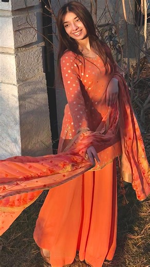 Roopan Grewal’s Stitchcraft on Instagram: "When heritage glows differently ✨ Sunset orange sharara, Banarasi tilla, modern phulkari, and mirror-kissed details— a traditional artwork, intricately contemporarized. @amreen_grewal15 #punjabibride #punjabisuit #punjabiwedding #handwork #sharara"