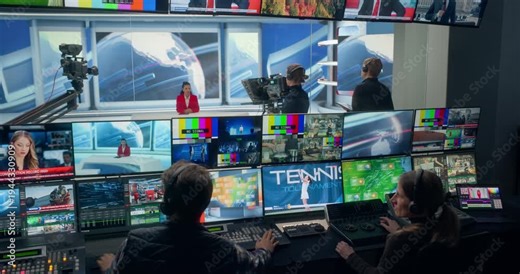 Cable News Control Room Runs a Live Studio Newscast, With Producers Switching Camera Views, Coordinating Broadcasting, Professional Anchor, Shows, Sports Segments for a TV Station Channel Stream.