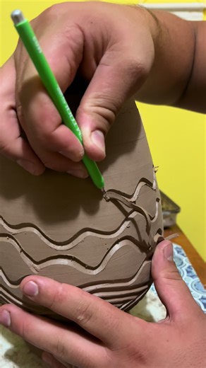 A little dance of the tool around the pot. I love carving clay. Follow for more carved pottery