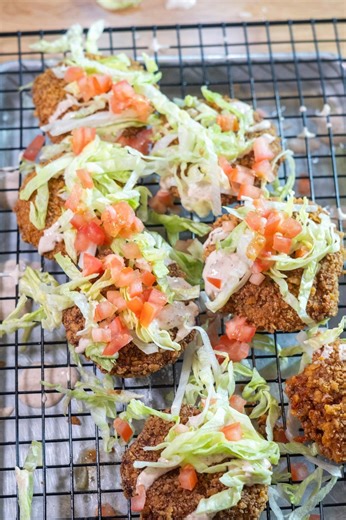 These Frito Pie Croquettes will be a game changer at your next social gathering. Tasty Frito Pie Chili (store-bought is fine, too): 1 lb ground beef 1 onion, diced 2 cloves garlic, minced 1 (28-ounce) can whole peeled tomatoes 1 tbsp chili powder 1 tbsp paprika 1 tbsp cumin 1½ tsp salt 1 tsp cayenne pepper Breading: 1 (9.25-ounce) bag Fritos® corn chips Flour, for coating 2 large eggs, beaten Neutral oil, for frying @geeksandgrubs | Tasty