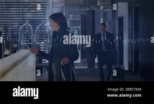 Woman tapping phone at hotel desk checking booking as waveform animating onscreen while man walking. Travelers, reception, lobby, luggage, suitcase, corridor, interior Stock Video Footage - Alamy