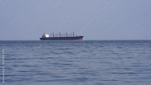 A large ship slowly sails by on the horizon in timelapse mode Stock Video