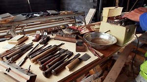 clip-1078871084-jointer-sharpens-equipment-on-grinder-different-table