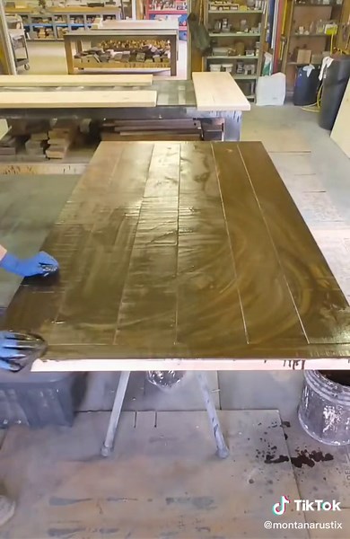 First stain color on a rustic alder dining table. Put it on like you mean it. #shoplife #furnituremaker #fulltimemaker #woodshop #finishcarpentry #woodworking #woodtok #montana
