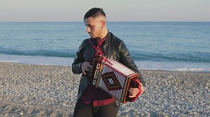 Man playing music with accordion on the beach - Free Stock Video