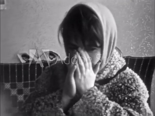 Shy girl face embarrassed to filmed, covering her face with hands, house indoor. Adorable shame smile. Young female tender expression. Blush gesture. Old film. Archival retro 1960s. Vintage archive