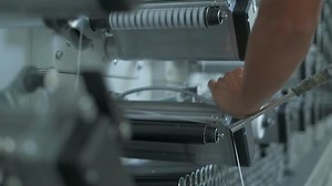 Operator works on polymer thread winding machine
