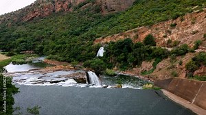 View from the dam wall, looking out over the sluice at Hartbeespoort dam showing the sloping rock layers and a number of cascades and waterfalls downstream from the wall of this dam in South Africa. Stock Video