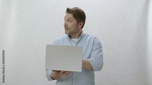 Typing email or message on keyboard on laptop on white background, chatting, shopping, working online. Portrait of man working at computer.Shows advertising space at the top of the screen.