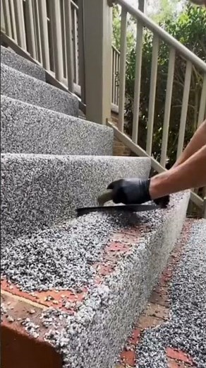 the process of plastering colored sand powder mixture on the terrace stairs of a house #construction