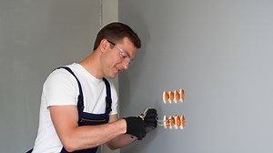 Professional electrician working on the electrical system, home improvement and repair concept