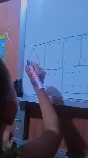 Child Draws Words on Whiteboard with Marker