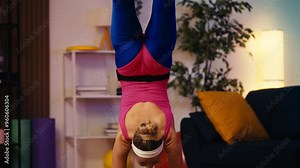 Funny woman in activewear trying to do front walkover at home, sad with result