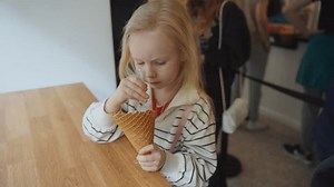 Cute little girl eating ice cream in a cafe. 4k