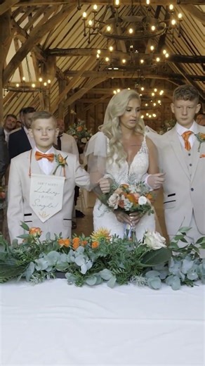 Bride walks down the aisle with her sons