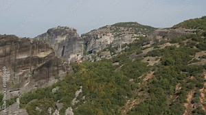 Meteora rocks and monastery complex occupied by tourists 4K tilting video