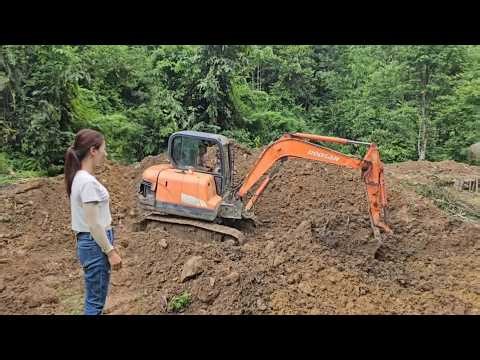 The entire process of the excavator digging the pond during heavy rain.