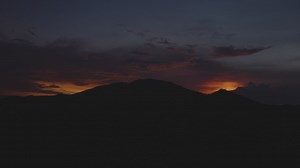 Sunset behind mountain silhouette  - Free Stock Video
