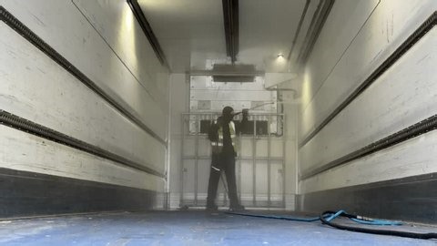 clip-3995842773-worker-using-high-pressure-washer-sanitize-front