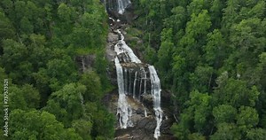 Whitewater Falls in Nantahala National Forest, North Carolina, USA. Beautiful landscape of high waterfall with falling down clear water from rocky boulders between green lush woods