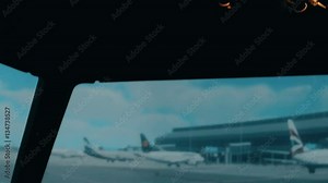 Close shot of modern aircraft cabin with buttons and knobs. Interior of Airbus A319 A320 A321. Panorama from overhead panel to pedestal trough centre panel and windshield. Other planes and airport