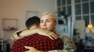 Sad female service member embracing husband, leaving for service, separation Stock Video