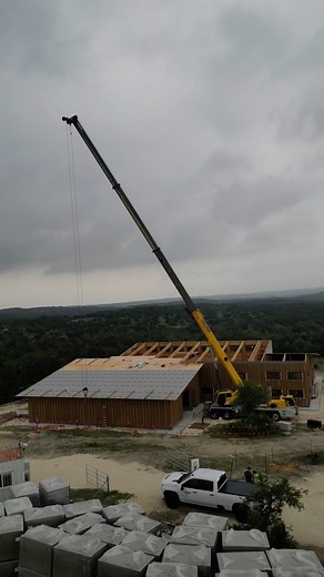 Mass Timber Building made with all LVL materials! 4’x32’x1.5” LVL Plywood, Columns & Beams from all LVL materials too. We are call this Mass Ply Light Framing. The drone flies into the Garage/Barn area. House is on the back. All wrapped in peel&stick @dorken_systems Delta Vent SA for a vapor open WRB then all OUT-sulation is @rockwoolna Comfotboard. Roof top insulation is next after the rest of the roof panels fly into place. No interior insulation needed. No drywall either. @strongtie makes all