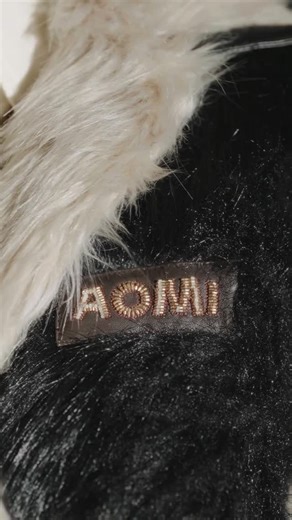 AOMI on Instagram: "A black-and-white faux fur varsity jacket with leather-striped sleeves, welt pockets, snap buttons, and a hand-embellished Aomi logo—classic athletic form refined through rich textures and leather detailing. Aomi Fall/Winter 2025 Available online at www.officialaomi.com"