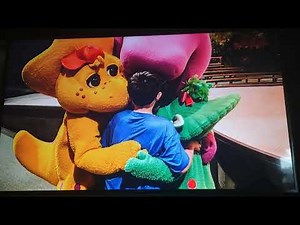A little Boy group hugging Barney baby Bop and BJ at universal studios Orlando