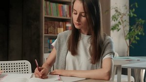 Caucasian woman businesswoman classroom library teacher student girl study learning writing notebook notes exam preparation female business indoor education university high school lesson write course