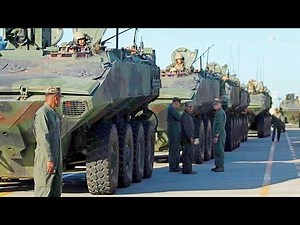 ACV amphibious combat vehicles are loaded onto a US Navy landing craft.