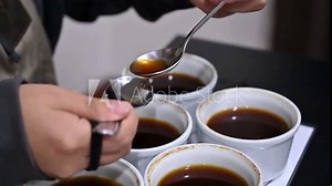 Professional barista tasting different types of coffee in cup tasters. Coffee degustation