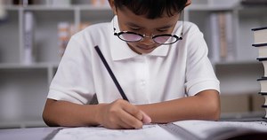 Download A boy doing homework. for free