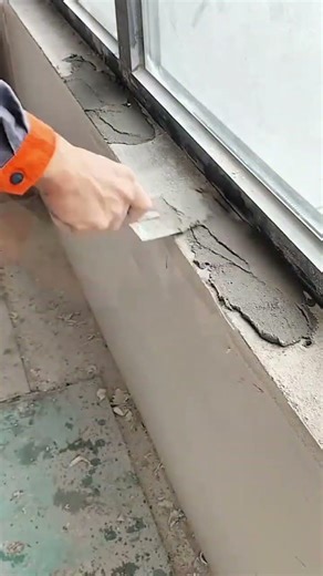 Applying smooth plaster evenly onto window ledge surface