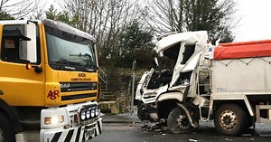 Aftermath of head-on bus and lorry crash after driver is cut free